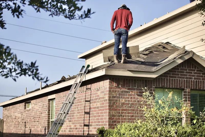 Professional roofer working on a residential roof in Strathmore